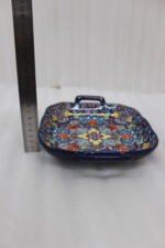 Square ceramic 6-inch Marrakesh decorative bowl with vibrant floral mandala pattern and side handles sitting on a wooden table.