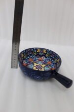 6-inch vibrant blue decorative Marrakesh ceramic bowl with colorful mosaic patterns and side handle on a wooden table.