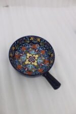 6-inch vibrant blue decorative Marrakesh ceramic bowl with colorful mosaic patterns and side handle on a wooden table.