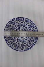 Pair of decorative blue and white Marrakesh ceramic floral bowls in 6-inch and 8-inch sizes sitting on a marble kitchen countertop.