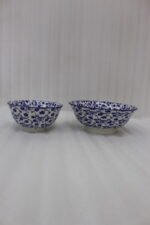 Pair of decorative blue and white Marrakesh ceramic floral bowls in 6-inch and 8-inch sizes sitting on a marble kitchen countertop.