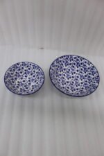 Pair of decorative blue and white Marrakesh ceramic floral bowls in 6-inch and 8-inch sizes sitting on a marble kitchen countertop.
