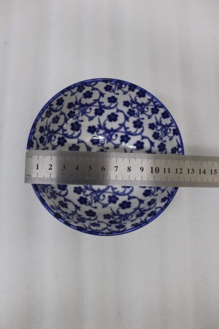 Pair of blue and white handcrafted decorative Marrakesh ceramic bowls in 5-inch and 8-inch sizes on a marble countertop