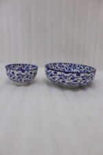 Pair of blue and white handcrafted decorative Marrakesh ceramic bowls in 5-inch and 8-inch sizes on a marble countertop