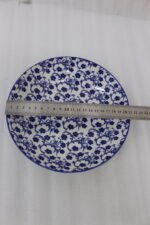 8-inch ceramic decorative Marakesh bowl with intricate blue and white floral pattern resting on a white countertop