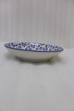 8-inch ceramic decorative Marakesh bowl with intricate blue and white floral pattern resting on a white countertop