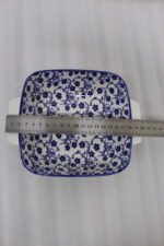Square ceramic Marrakesh serving dish with blue and white floral pattern resting on a kitchen countertop