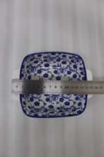 Square ceramic Marrakesh serving dish with blue and white floral pattern resting on a kitchen countertop
