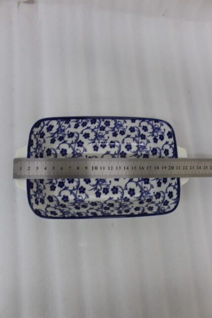 9-inch decorative Marrakech blue and white floral ceramic rectangular serving dish with handles on a wooden kitchen counter