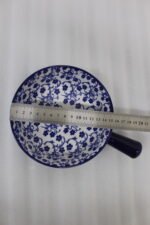 Decorative 6-inch blue and white floral ceramic Marakesh serving dish with single side handle on a wooden kitchen countertop.