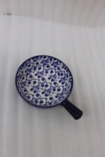 Decorative 6-inch blue and white floral ceramic Marakesh serving dish with single side handle on a wooden kitchen countertop.