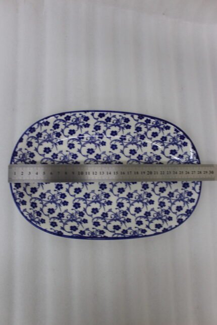 11-inch oval ceramic decorative Marrakesh serving dish with blue and white floral patterns on a light marble countertop.