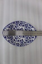 Two decorative Marakesh blue and white floral ceramic serving dishes with handles resting on a kitchen countertop.