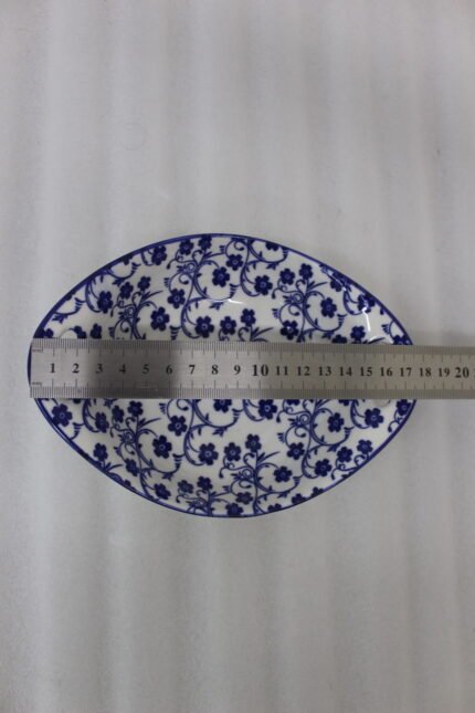 Two decorative Marakesh blue and white floral ceramic serving dishes with handles resting on a kitchen countertop.