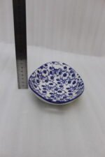 Two decorative Marakesh blue and white floral ceramic serving dishes with handles resting on a kitchen countertop.