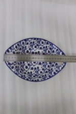 Two decorative Marakesh blue and white floral ceramic serving dishes with handles resting on a kitchen countertop.