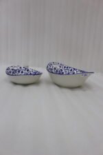 Two decorative Marakesh blue and white floral ceramic serving dishes with handles resting on a kitchen countertop.