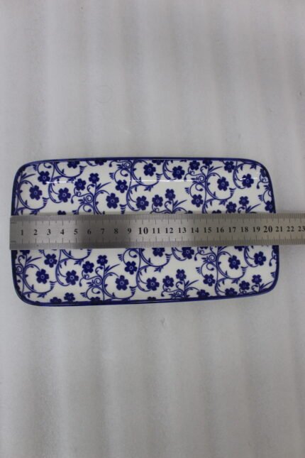 Two rectangular blue and white decorative Marrakesh serving dishes in 8-inch and 10-inch sizes displayed on a marble countertop.