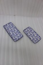 Two rectangular blue and white decorative Marrakesh serving dishes in 8-inch and 10-inch sizes displayed on a marble countertop.
