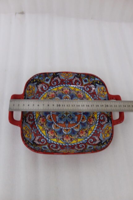 Three vibrant red Moroccan Marrakech decorative ceramic bowls with handles set on a wooden countertop