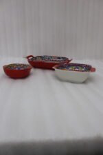 Three vibrant red Moroccan Marrakech decorative ceramic bowls with handles set on a wooden countertop