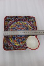 Square ceramic Marrakech serving platter with intricate colorful mosaic patterns and an attached side dip bowl on a wooden countertop.