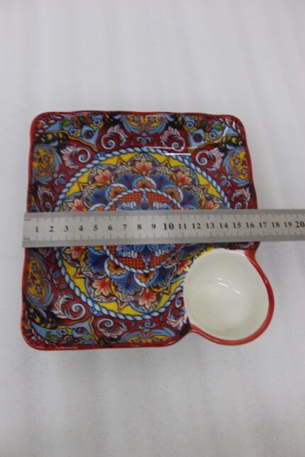 Square ceramic Marrakech serving platter with intricate colorful mosaic patterns and an attached side dip bowl on a wooden countertop.