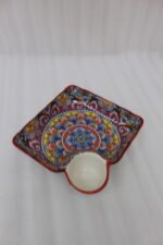 Square ceramic Marrakech serving platter with intricate colorful mosaic patterns and an attached side dip bowl on a wooden countertop.