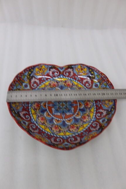 Decorative Marrakesh serving plate featuring vibrant hand-painted mosaic mandala patterns on a wooden countertop.