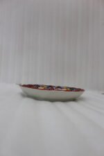 Decorative Marrakesh serving plate featuring vibrant hand-painted mosaic mandala patterns on a wooden countertop.