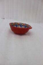 4-inch hand-painted decorative Marrakech ceramic piyali bowl with vibrant blue, yellow, and red pattern resting on a wooden table.
