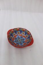 4-inch hand-painted decorative Marrakech ceramic piyali bowl with vibrant blue, yellow, and red pattern resting on a wooden table.