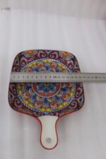 6.5-inch decorative Marrakech square ceramic serving platter with intricate mandala pattern and handle on a wooden countertop