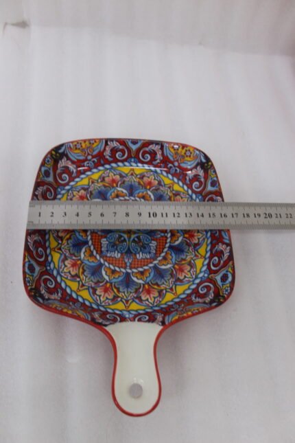 6.5-inch decorative Marrakech square ceramic serving platter with intricate mandala pattern and handle on a wooden countertop