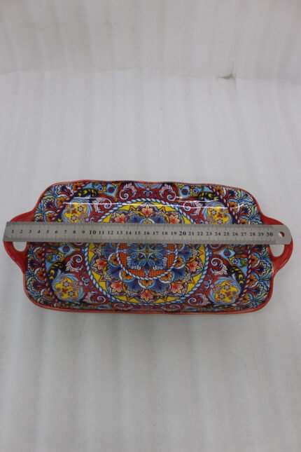 Vibrant 13-inch decorative Marrakech ceramic serving dish with colorful mosaic patterns and built-in side handles displayed on a wooden countertop.