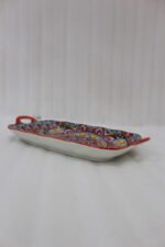 Vibrant 13-inch decorative Marrakech ceramic serving dish with colorful mosaic patterns and built-in side handles displayed on a wooden countertop.