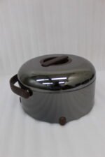 Three modern mirror-finish stainless steel insulated hot pots with wooden arch handles on a kitchen countertop.