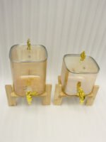 Ribbed amber glass beverage dispenser with gold tap and pineapple lid finial on a wooden stand