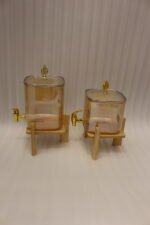 Ribbed amber glass beverage dispenser with gold tap and pineapple lid finial on a wooden stand