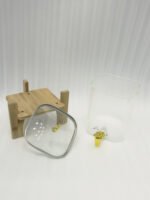 Two ribbed glass beverage dispensers with gold spigots on wooden stands sitting on a kitchen countertop