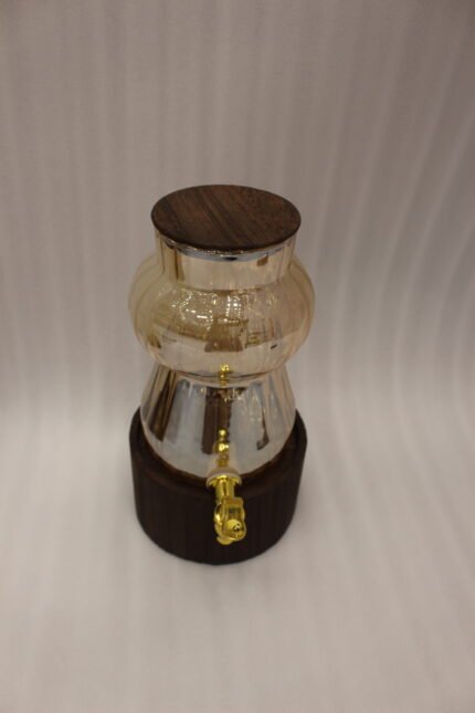 3.2L fluted amber glass beverage dispenser with wooden lid, wooden base, and gold spigot on a kitchen counter