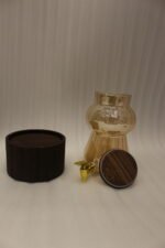 3.2L fluted amber glass beverage dispenser with wooden lid, wooden base, and gold spigot on a kitchen counter