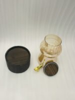 3.2L fluted amber glass beverage dispenser with wooden lid, wooden base, and gold spigot on a kitchen counter