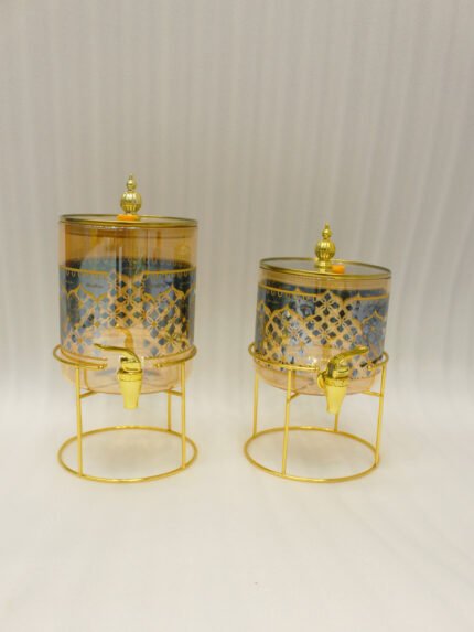 Luxury amber glass beverage dispenser with intricate blue pattern on a decorative gold metal stand