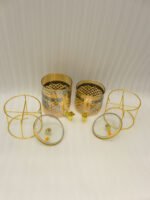 Luxury amber glass beverage dispenser with intricate blue pattern on a decorative gold metal stand