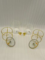 Two luxury clear glass beverage dispensers with gold deer lid handles and matching metallic stands on a marble countertop
