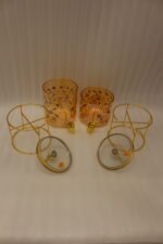 Two elegant clear glass drink dispensers with fruit prints, gold spigots, and gold deer lid handles resting on matching metal wire stands.