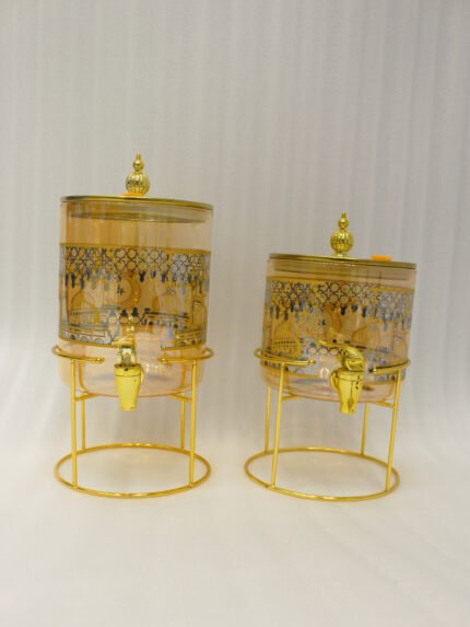 Amber tinted glass beverage dispenser with intricate Islamic mosque gold pattern on a metal stand.