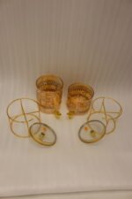 Amber tinted glass beverage dispenser with intricate Islamic mosque gold pattern on a metal stand.