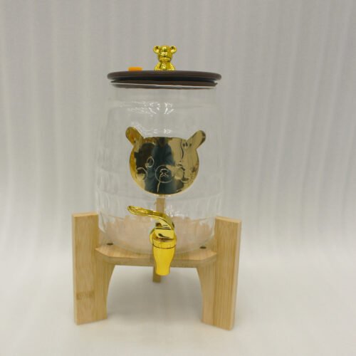 3.5 liter ribbed glass beverage dispenser with polished gold base, lid, and spigot on a kitchen counter
